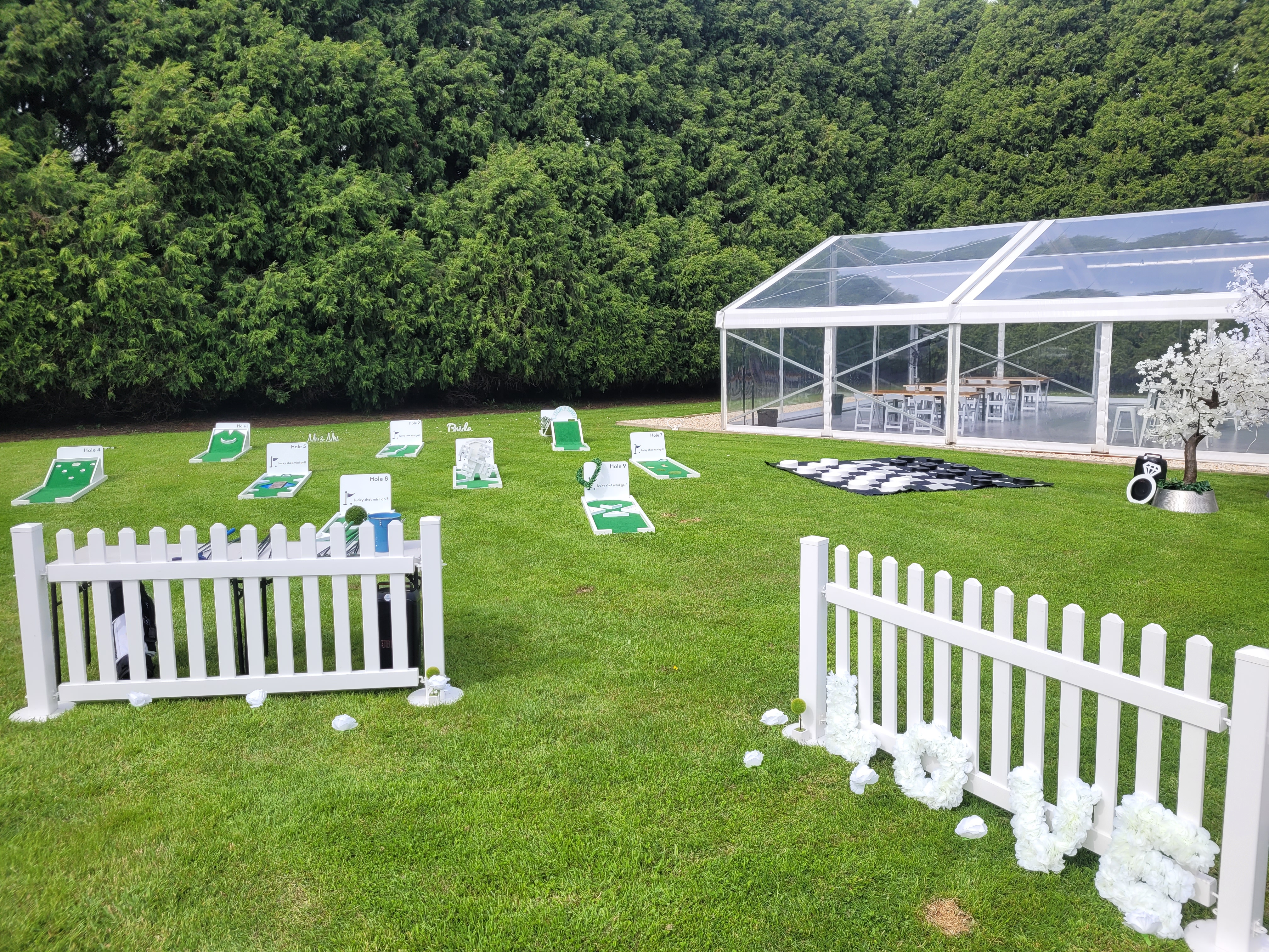 Elegant white mini golf course setup at a wedding venue